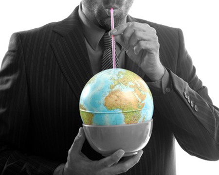 Businessman drinking the world, a power leader metaphor